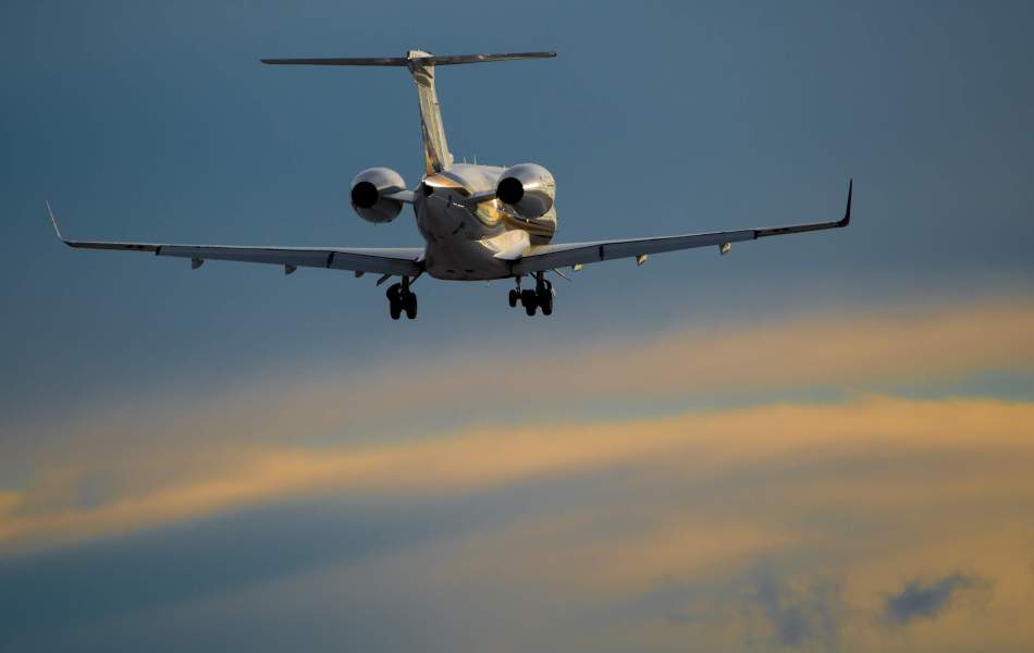 AirSprint Legacy 450 airplane above clouds