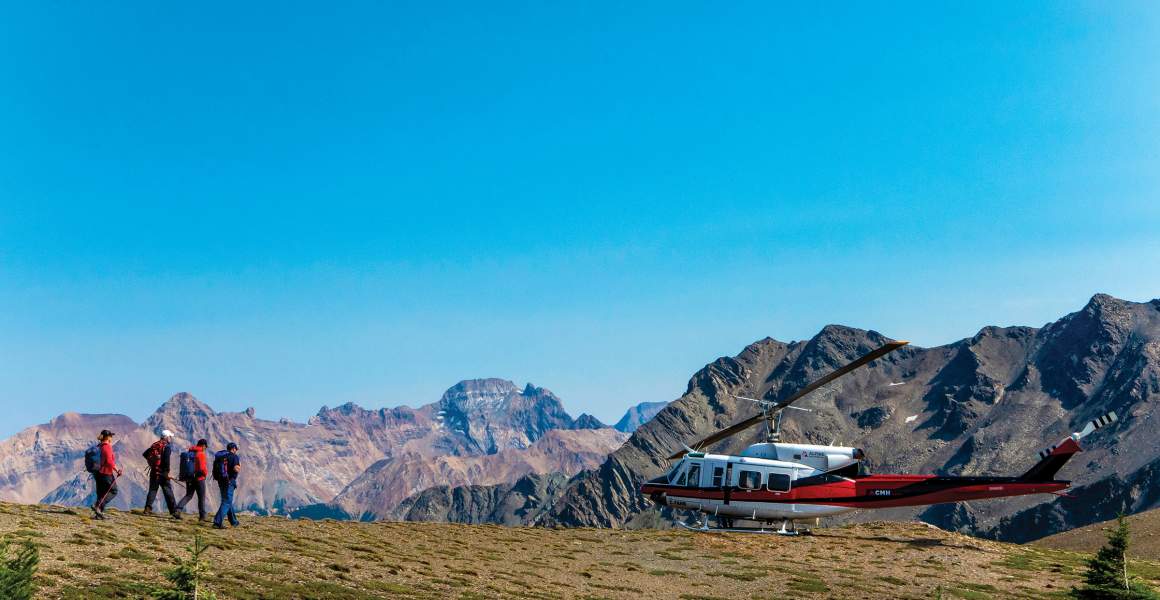 Hikers return to the helicopter, completing a memorable mountain adventure | AirSprint Private Aviation
